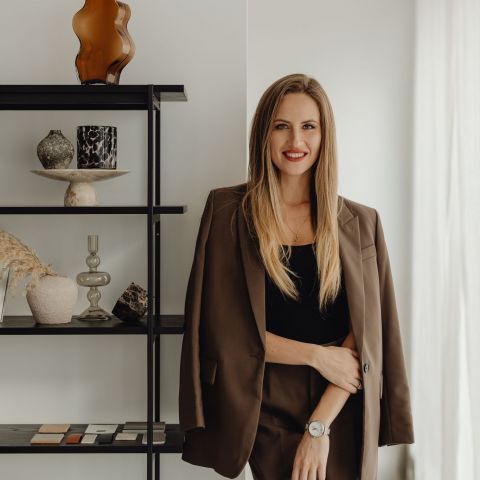 The Dorian leasing representative in business attire smiling in modern office