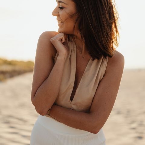 The Dorian Smiling resident on a beach at sunset